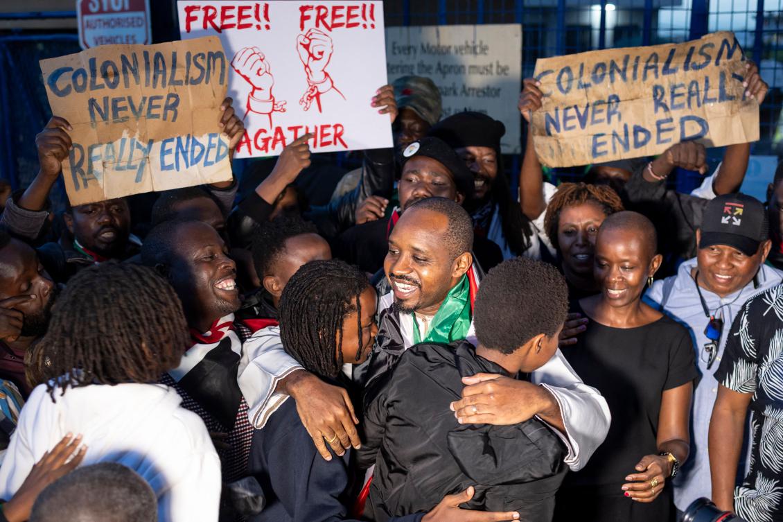 Kenyan journalist and human rights activist Boniface Mwangi, center, was arrested alongside Ugandan activist and journalist Agather Atuhaire in Tanzania. (AFP)
