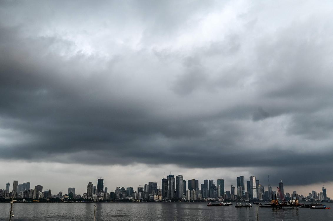 Dark monsoon clouds hover over the city skyline in Mumbai on May 22, 2025. (AFP)