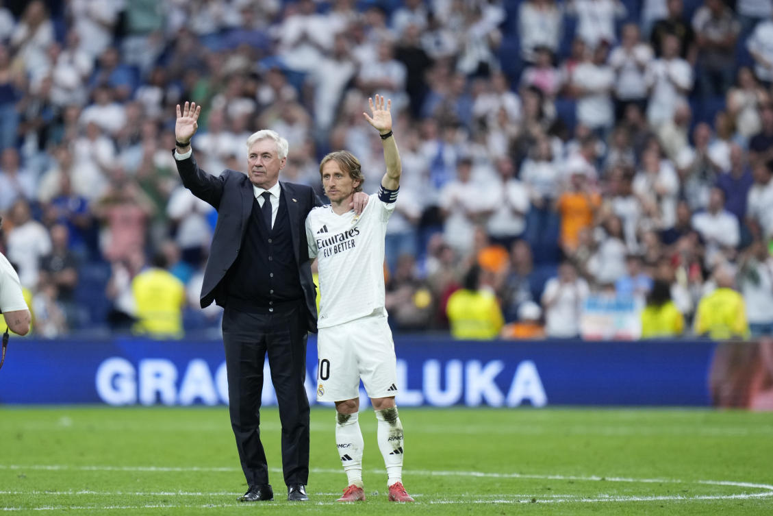 Real Madrid’s head coach Carlo Ancelotti and Luka Modric wave to the crow after their La Liga match against Real Sociedad at Santiago Bernabeu stadium in Madrid, May 24, 2025. (AP)