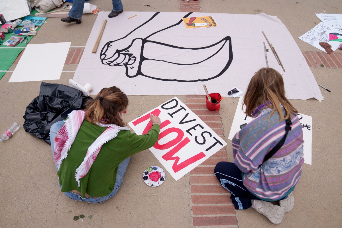 Pro-Palestine demonstrators make signs on the campus of UCLA on April 25, 2024 in Los Angeles, California. (AFP)