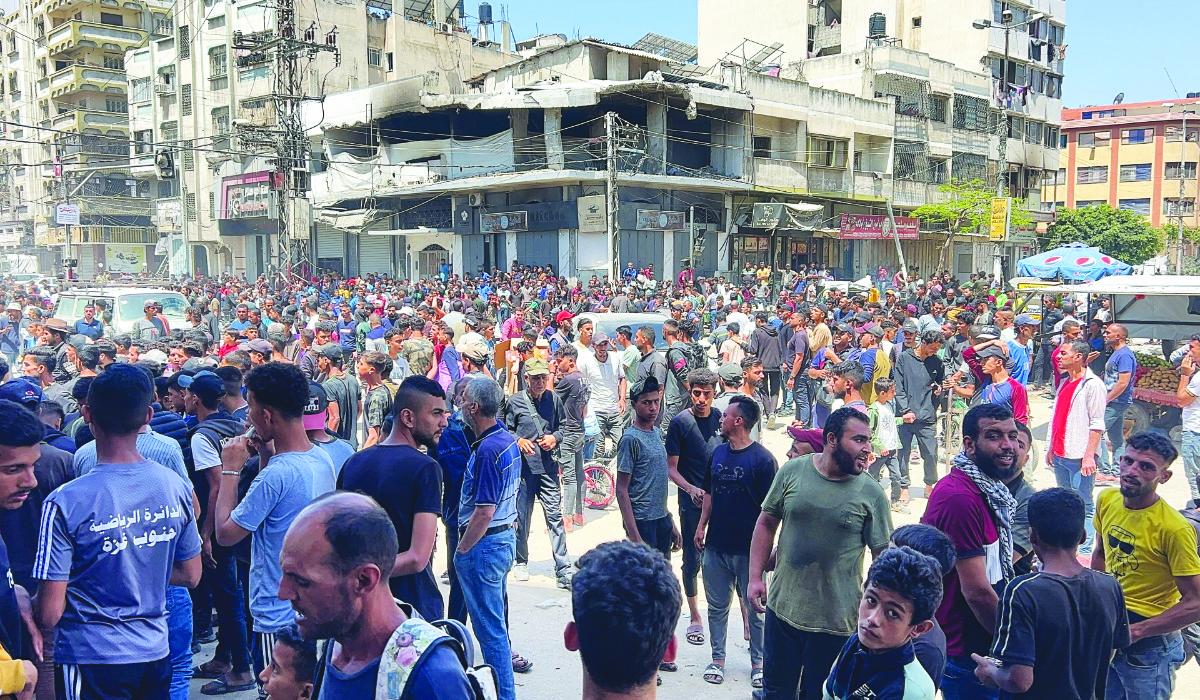 Palestinians wait to receive aid, in Gaza City, May 25, 2025. (REUTERS)