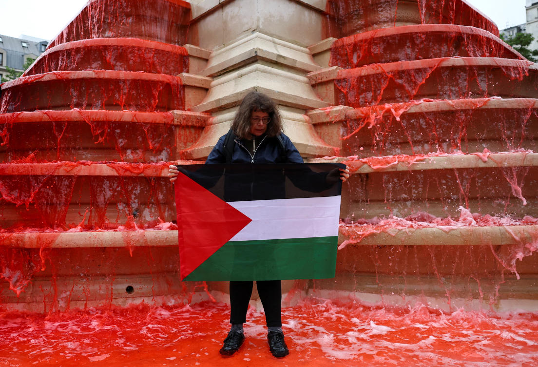 A person holds a Palestinian flag at a demonstration organised by Human rights activists from Amnesty International, Greenpeace, Oxfam and Medecins du Monde, to show support for Palestinians in the Gaza Strip and condemn civilian casualties, at the Fontaine des Innocents in Paris, France May 28, 2025. (REUTERS)