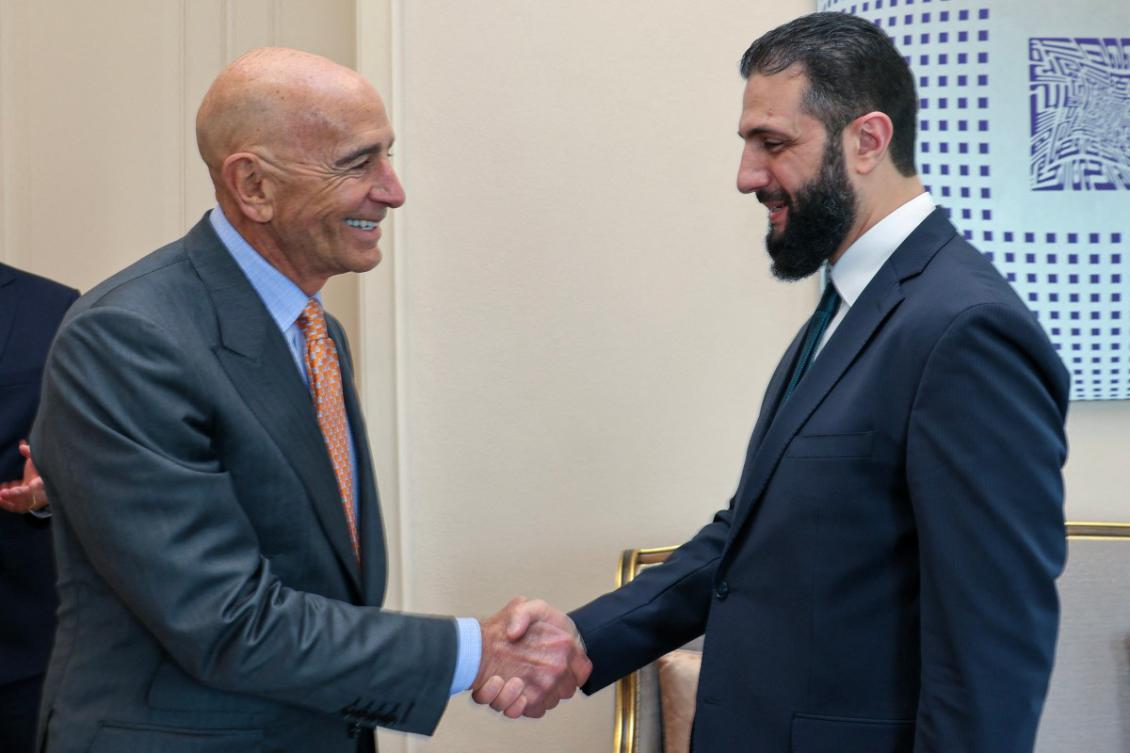 Thomas Barrack (L) shakes hands with Syria's jihadist-turned-interim President Ahmed al-Sharaa. (File/AFP)
