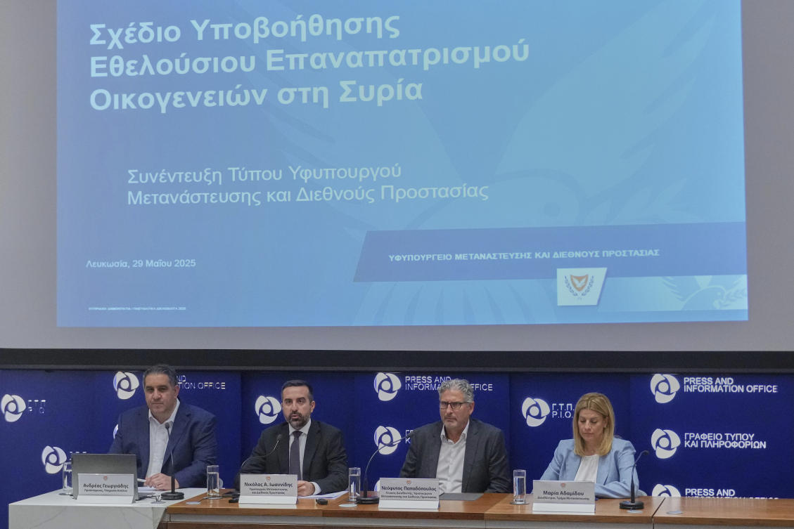 Cyprus’ deputy minister for migration Nicholas Ioannides, 2nd lt, explains how a new voluntary repatriation program for Syrian families will work, Nicosia, Cyprus, Thursday, May 29, 2025. (AP Photo)