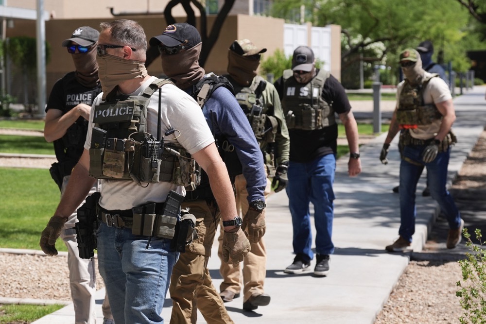 ICE and HSI police arrive at an immigration court to take someone into custody, in Phoenix. (AP)