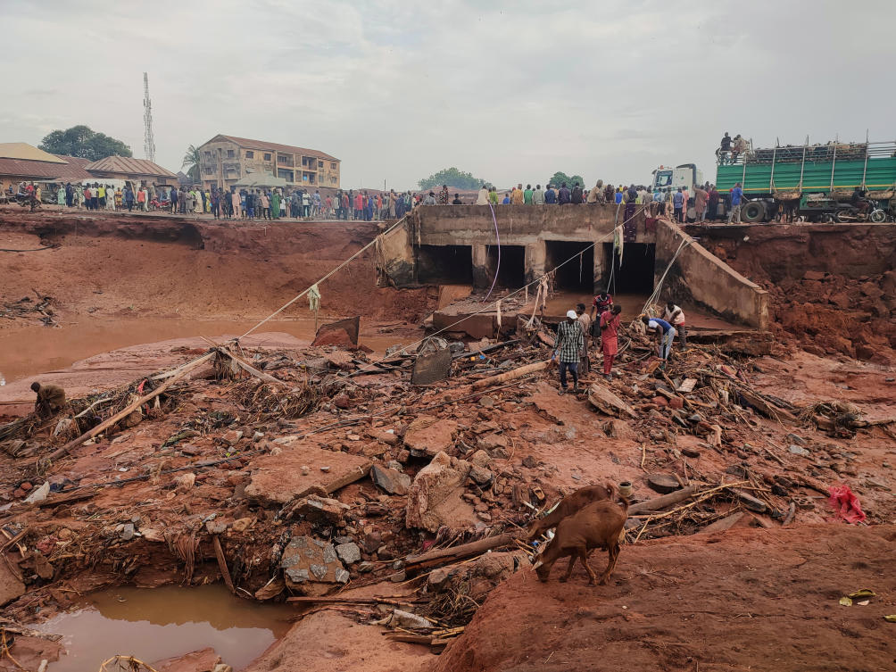 Above, people search in flooded area following a downpour in Mokwa, Nigeria on May 30, 2025. (AP)
