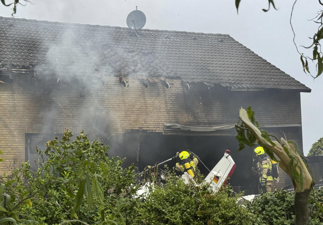 Firefighters work at the crash site after an airplane crashed into a residential building, in Korschenbroich, Germany, May 31, 2025. (AP)