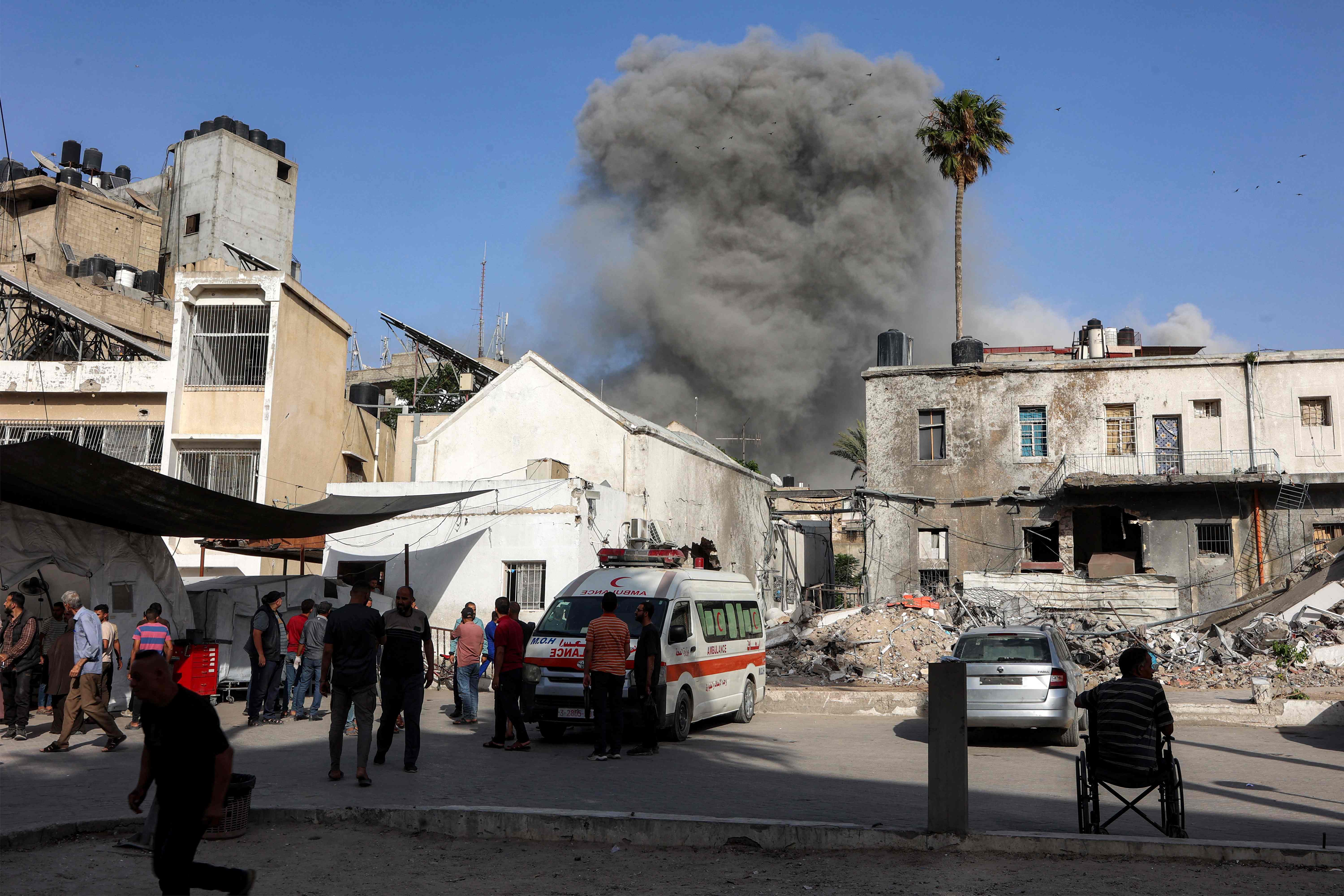 This picture taken from the grounds of the Ahli Arab Hospital, also known as the Maamadani (Baptist) Hospital, shows a cloud of smoke erupting following Israeli bombardment on a building in the Daraj neighbourhood of Gaza City on May 31, 2025. (AFP)