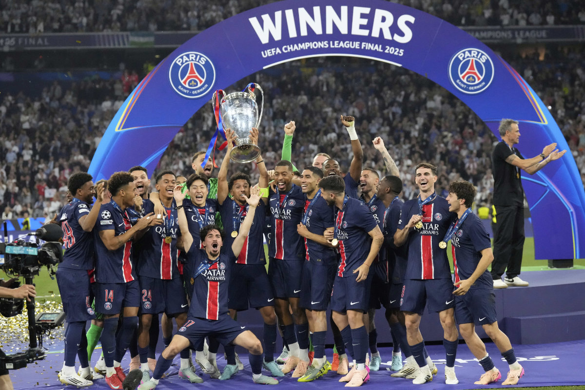 PSG players celebrate with the trophy after winning the Champions League final soccer match between Paris Saint-Germain and Inter Milan at the Allianz Arena in Munich, Germany, on Saturday, May 31, 2025. (AP Photo)