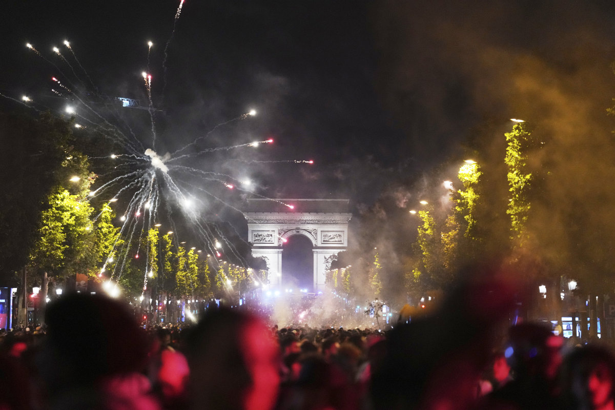Football fans celebrate PSG's victory on the Champs-Elysees avenue in Paris early Sunday. (AP)