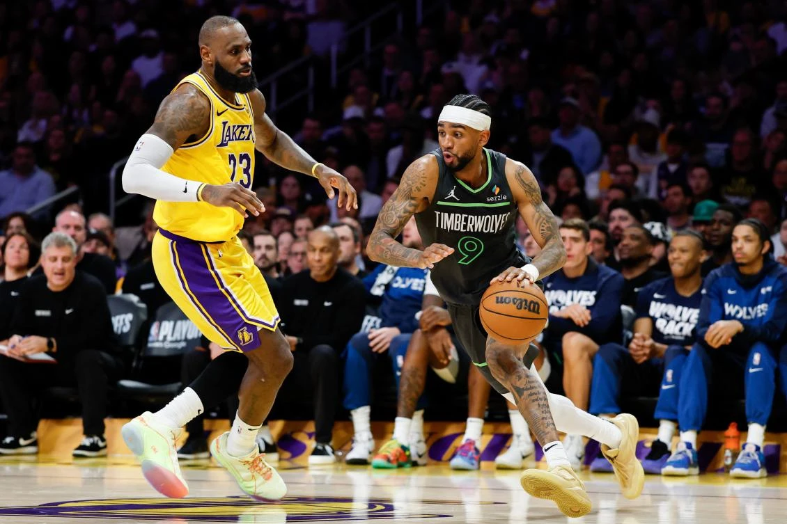 Nickeil Alexander-Walker of the Minnesota Timberwolves dribbles the ball against LeBron James of the Los Angeles Lakers during Game Five of the Western Conference First Round NBA Playoffs on April 30, 2025 in Los Angeles, California. (Getty Images via AFP)