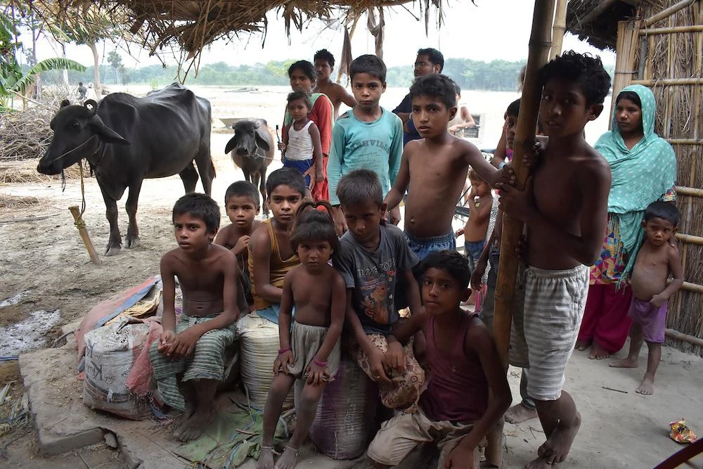 Above, children sit outside a house in the Indian state of Bihar. More than 100 children fell sick after eating lunch served at a government-run school in the city of Mokama in Bihar. (AFP file photo)
