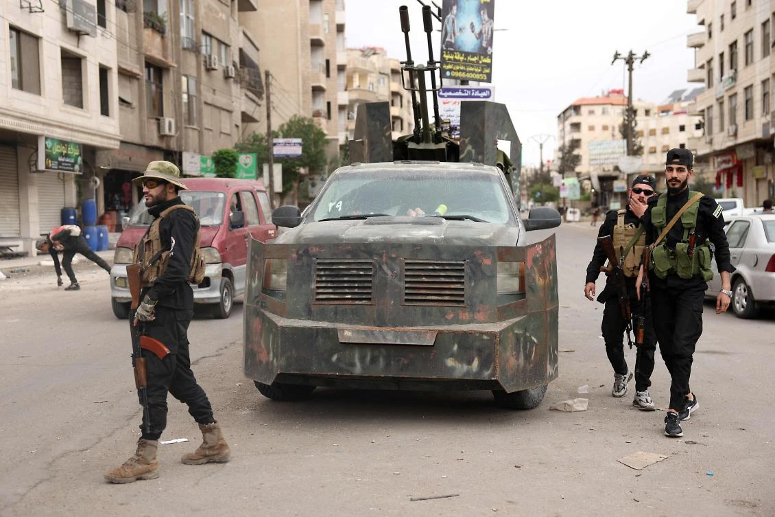 Members of Syria's security forces stand guard at a checkpoint in Ashrafiyat Sahnaya near Damascus, May 1, 2025. (AFP)