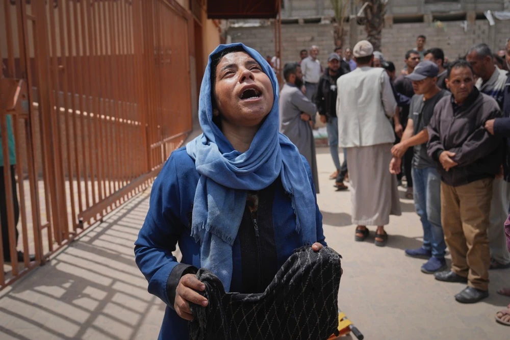 Islam Abu Sahloul mourns the death of her sister Lamia, 32, who was killed when an Israeli army strike hit a house killing at least five people, in Khan Younis, in the southern Gaza Strip, Thursday, May 1, 2025. (AP)