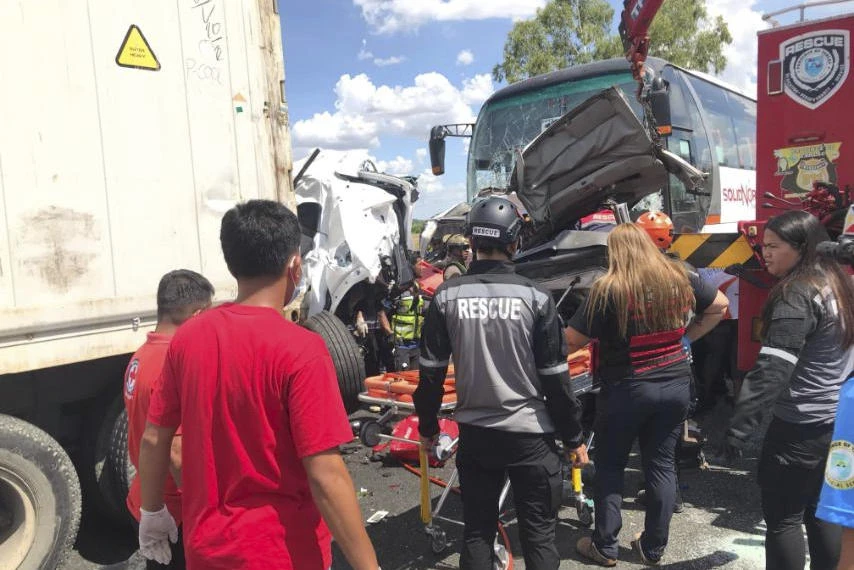 Rescuers check the site of a multiple-vehicle collision in Tarlac city, north of Manila, Philippines on May 1, 2025. (Philippine Red Cross via AP)