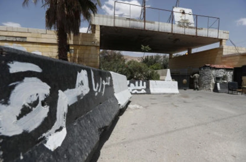 A Syrian soldier stands at the gate of a military base on the outskirts of Harasta, near Damascus, May 3, 2025. (AP)