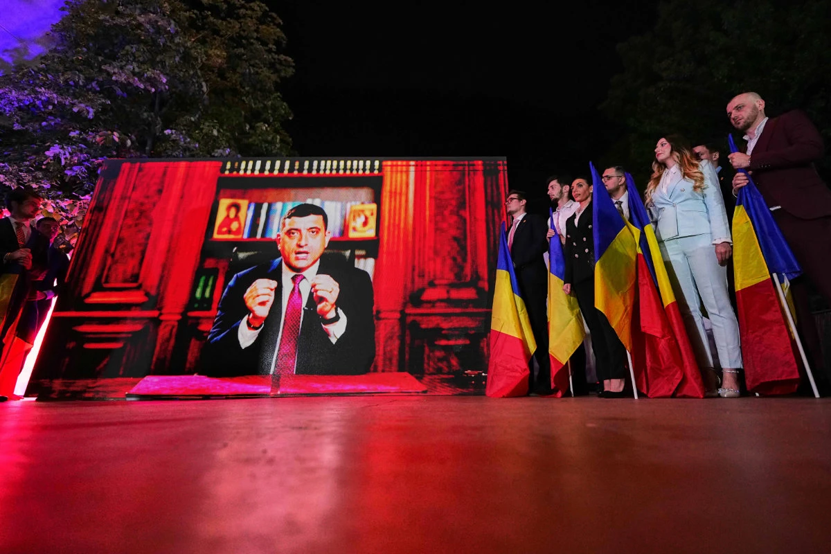 Presidential candidate George Simion addresses supporters via video link after polls closed for the first round of the country's presidential election redo in Bucharest, Romania, on May 4, 2025. (AP Photo)