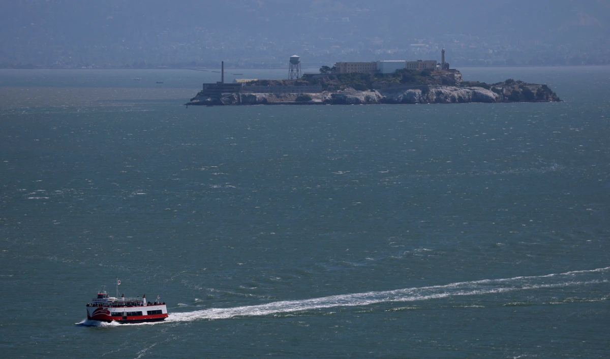 A tour boat passes Alcatraz Island on May 02, 2025 in San Francisco, California. (AFP)