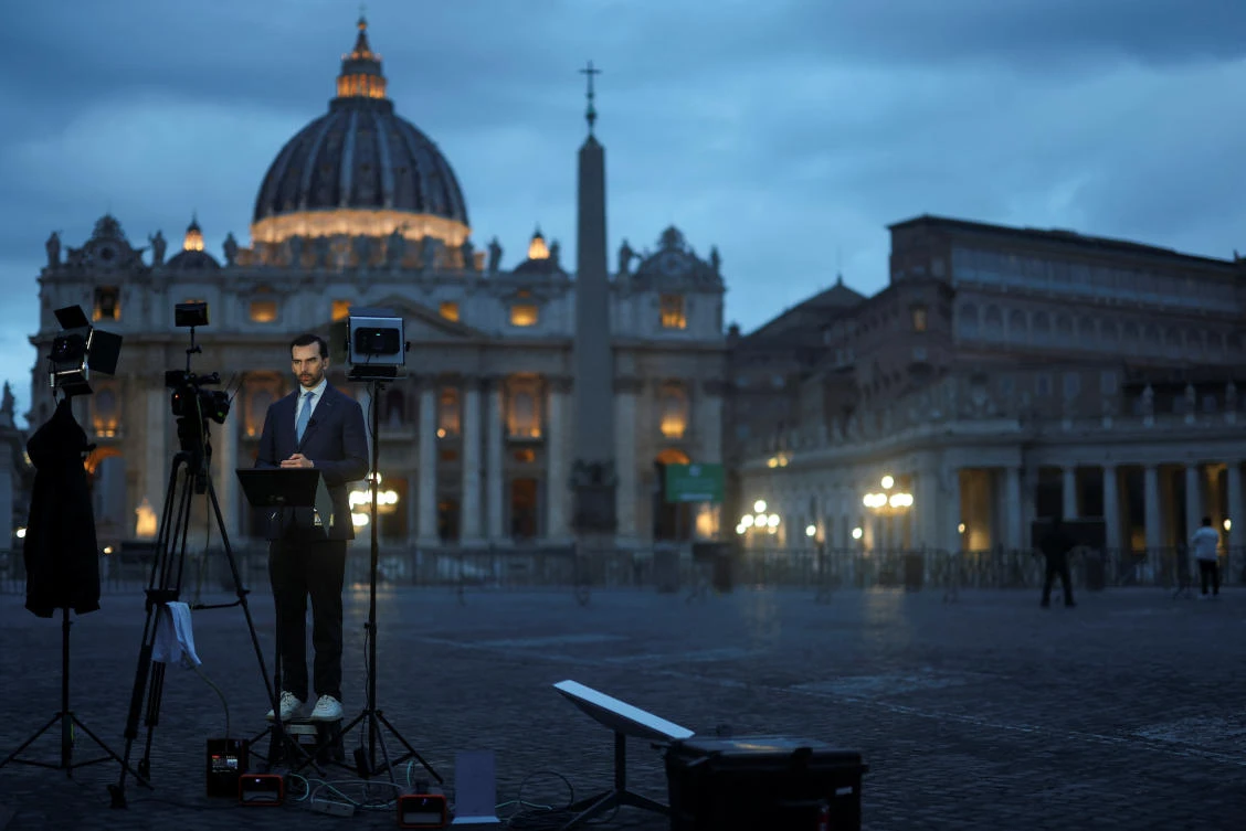 A member of the media reports from near the Vatican, ahead of the conclave to elect the next pope, as seen from Rome, Italy, May 6, 2025. (Reuters)