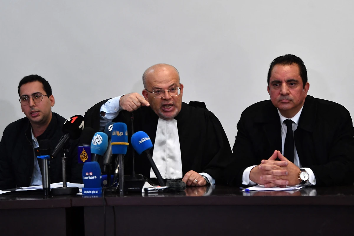 Samir Dilou (C), lawyer and member of the defence committee of detainees accused of involvement in a conspiracy case against state security, talks to reporters in front of the court in Tunis, Apr. 21, 2025. (AFP)