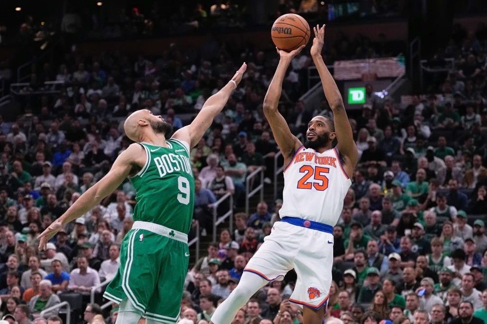 New York Knicks forward Mikal Bridges takes a shot over Boston Celtics guard Derrick White. (AP)