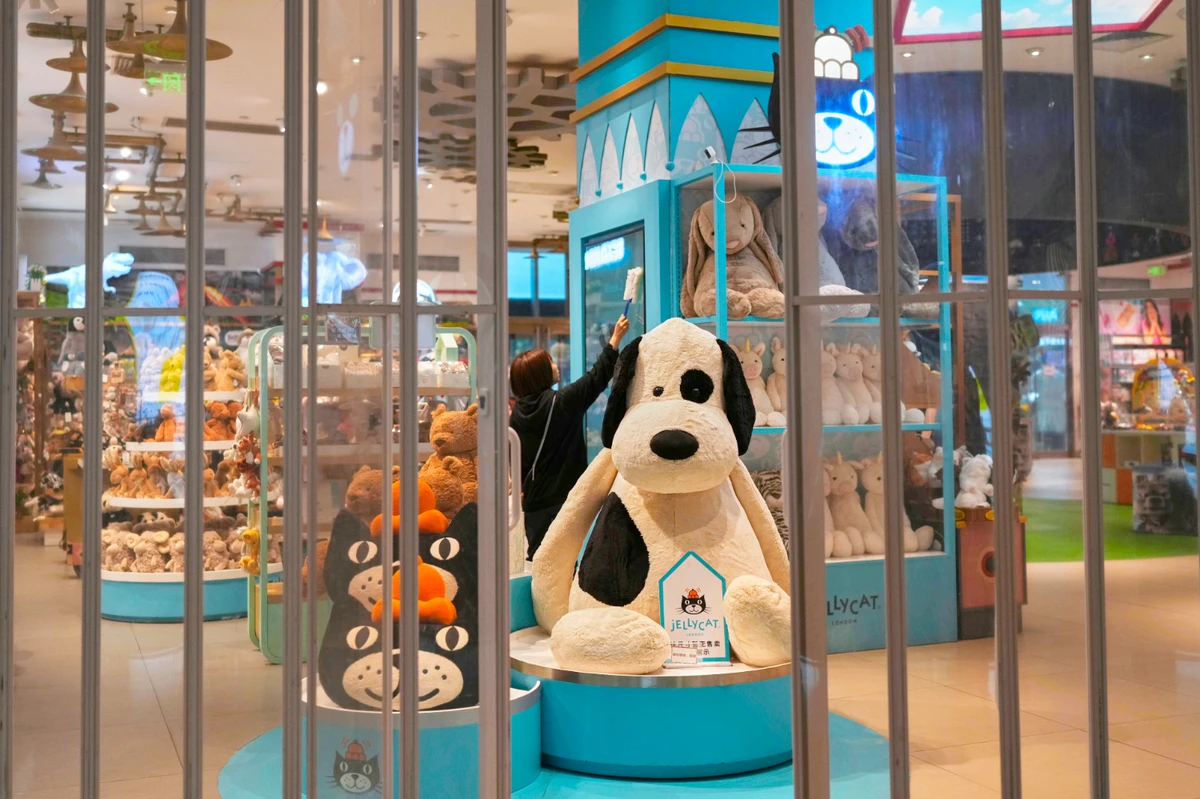 A staff member wipes a shelf at the American toy store FAO Schwarz before it opens business at a popular shopping mall in Beijing, Friday, May 9, 2025. (AP)