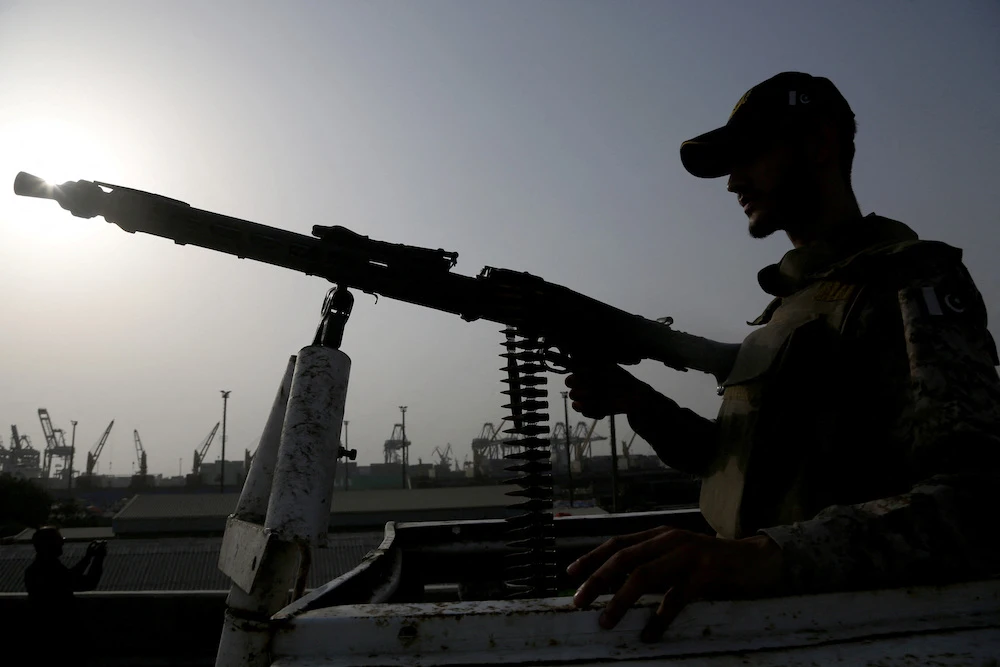 A paramilitary trooper mans a gun atop a vehicle as he keeps guard during a media tour of the Karachi Port, Pakistan, May 9, 2025. (Reuters)