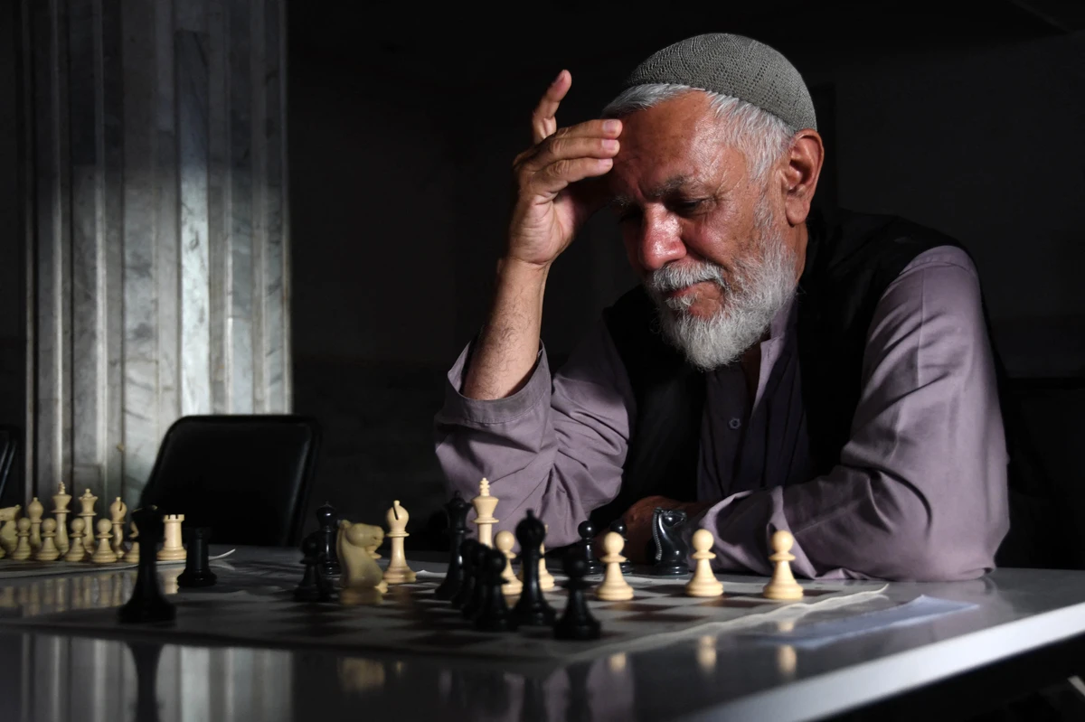 A participant looks on while playing a chess game during a chess tournament in Kandahar, Afghanistan, Jun. 30, 2022. (AFP)
