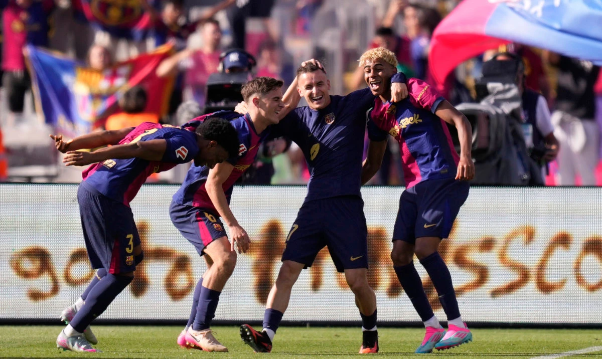 Barcelona players celebrate at the end of the Spanish La Liga soccer match between Barcelona and Real Madrid at the Lluis Companys Olympic Stadium in Barcelona, Spain, Sunday, May 11, 2025. (AP)