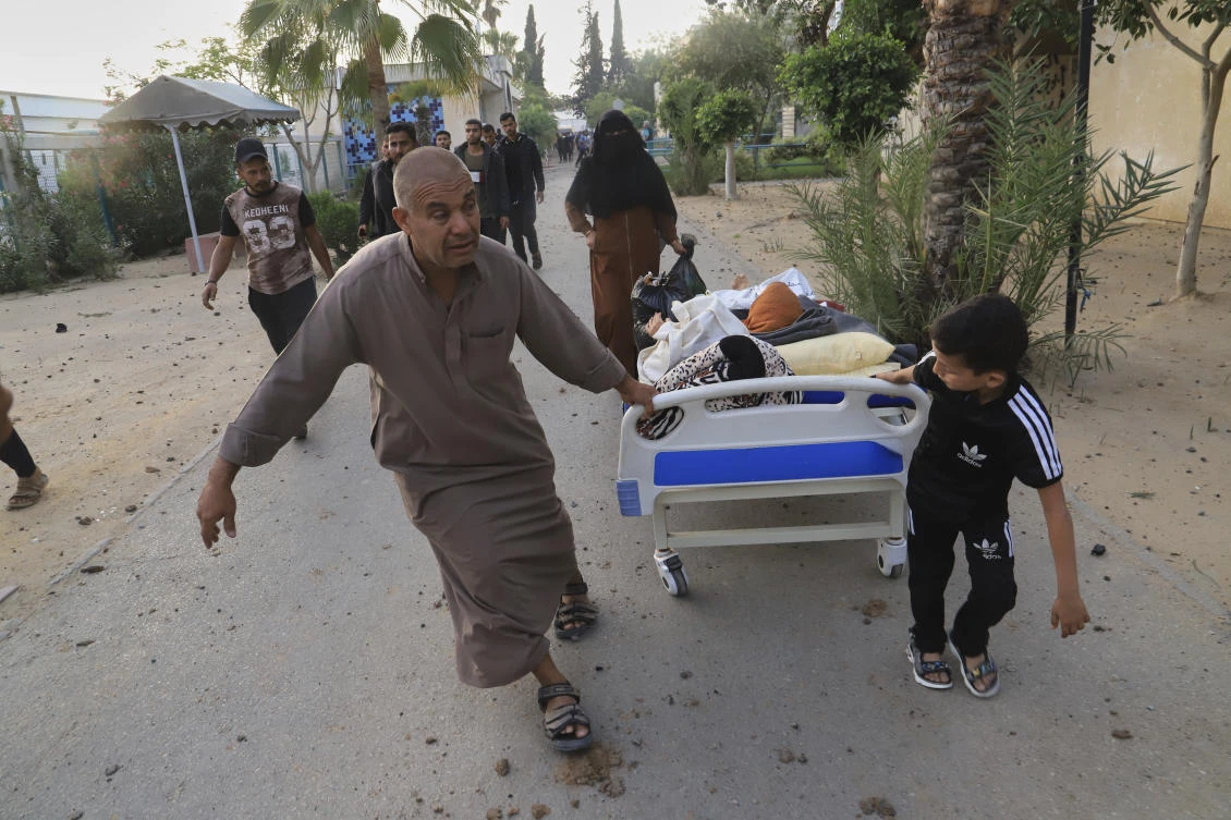 Palestinians evacuate patients from the European hospital in Khan Younis, Gaza, after it was hit by an Israeli army airstrike, May 13, 2025. (AP)