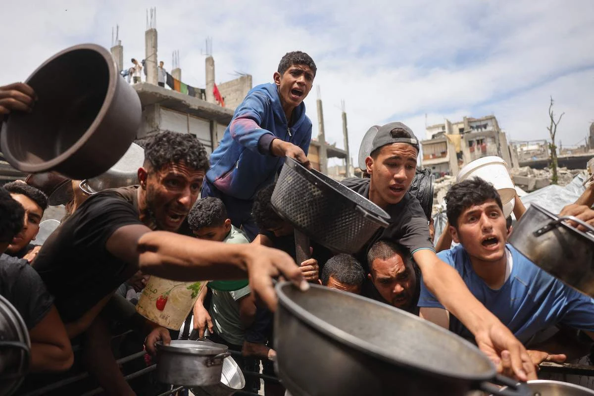 Palestinians struggle to get their food rations outside a crowded distribution centre in Beit Lahia in the northern Gaza Strip on Thursday. (AFP)