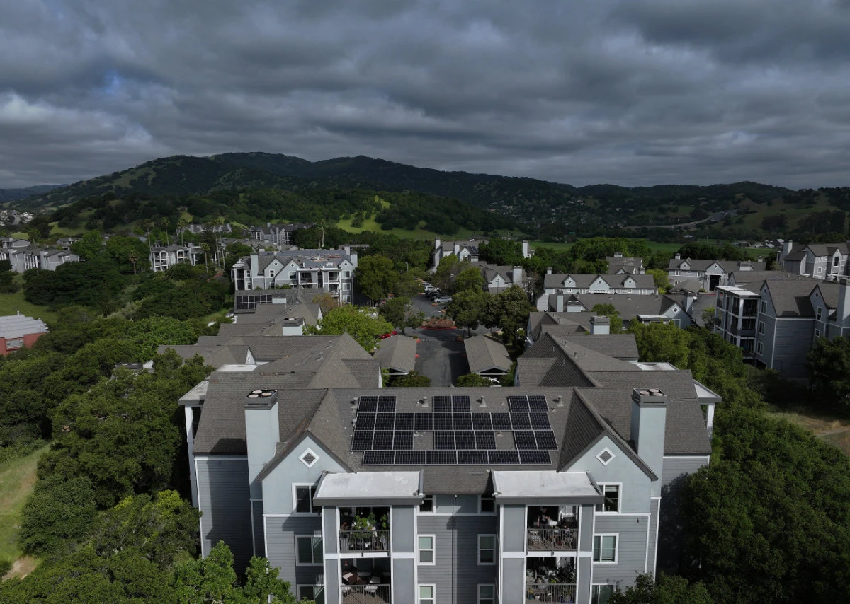 In an aerial view, solar panels are seen on the roof of an apartment complex in San Rafael, California. (AFP)