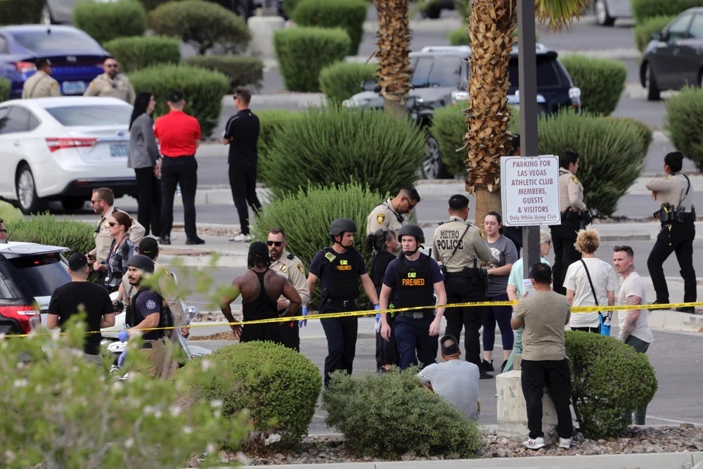 Las Vegas Metro Police officers talk with gym members after a shooting at a Las Vegas Athletic Club Friday, May 16, 2025, in Las Vegas. (Las Vegas Sun/AP)