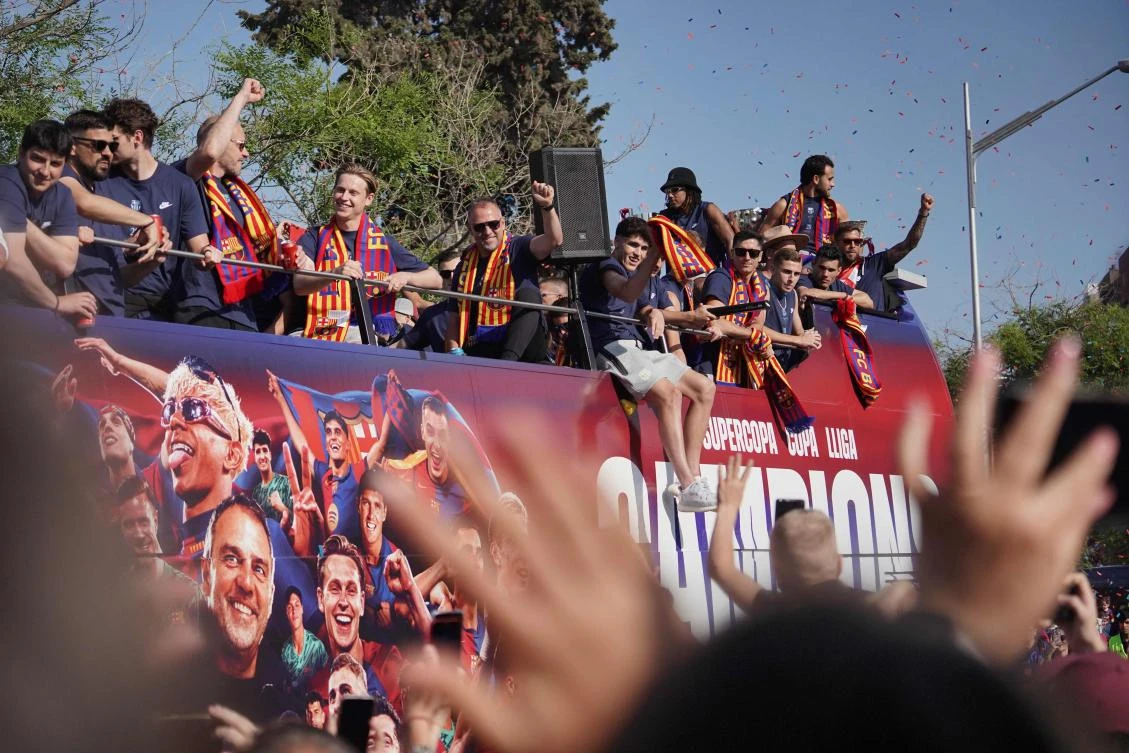 Barcelona’s German coach Hans-Dieter Flick and players ride in an open top bus to celebrate winning their 28th La Liga title in Barcelona, on May 16, 2025. (AFP)