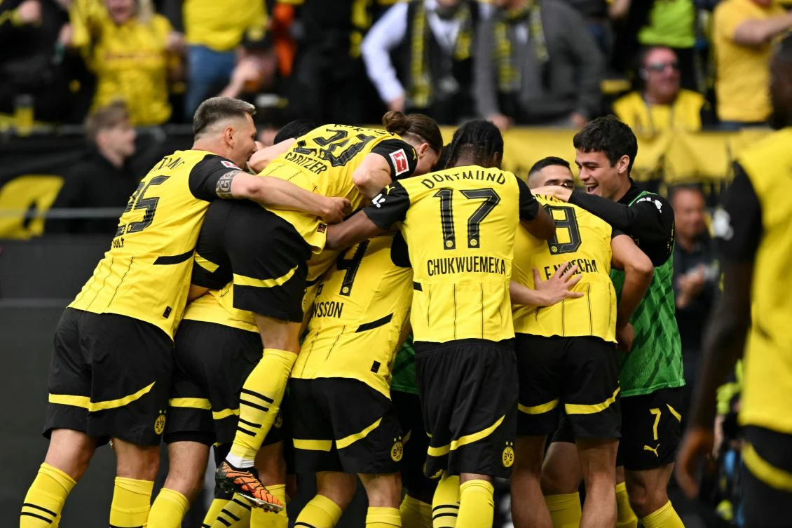 Dortmund’s players celebrate after midfielder Felix Nmecha scored their third goal during their Bundesliga match against Holstein Kiel in Dortmund, on May 17, 2025. (AFP)