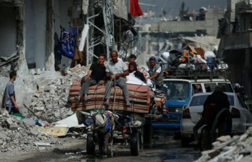 Palestinians ride a cart with belongings as they flee their homes, after Israeli air strikes, in the northern Gaza Strip May 17, 2025. (Reuters)