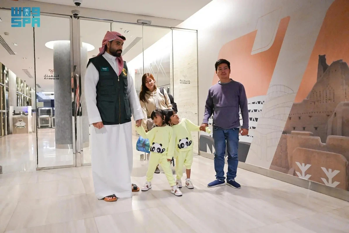 Conjoined twins Klea Ann and Maurice Ann, along with their parents, are escorted by a medical staff inside the King Abdullah Specialist Children’s Hospital in Riyadh on Saturday. (SPA photo)