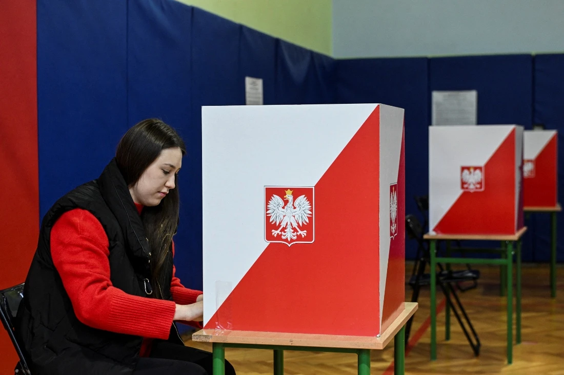 A woman casting her vote during the first round of Poland's presidential election at a polling station in Warsaw, Poland. (Reuters)