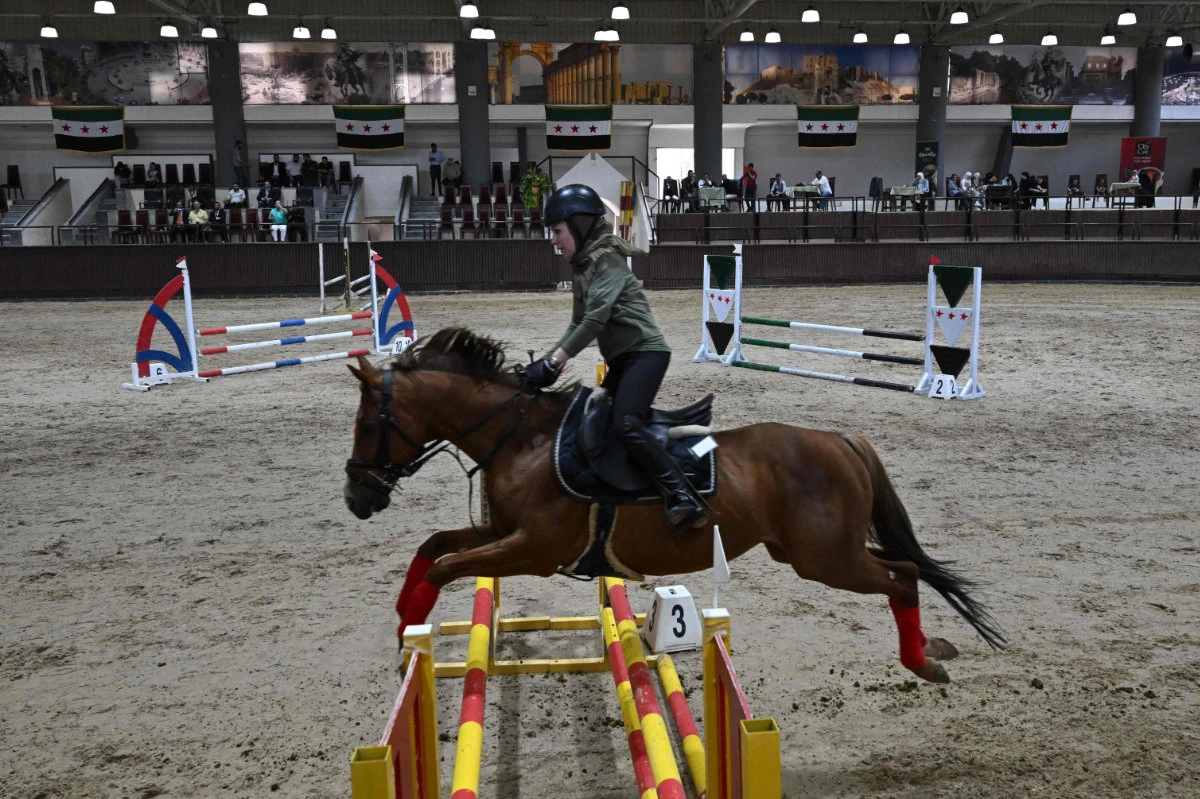 A horse rider competes during the fourth Al-Nasr Equestrian Show Jumping Championship at the Central Equestrian Club in Dimas, northwest of Damascus on May 9, 2025. (AFP)