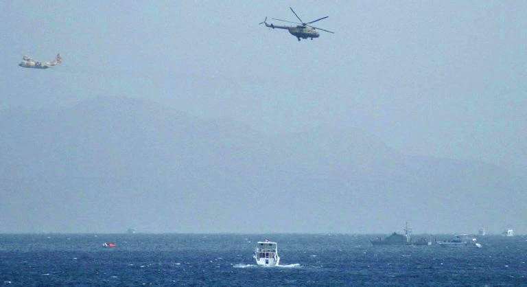 An Egyptian Hercules military aircraft (L) and a helicopter can be seen circling three miles off Sharm El Sheikh. (File/AFP)
