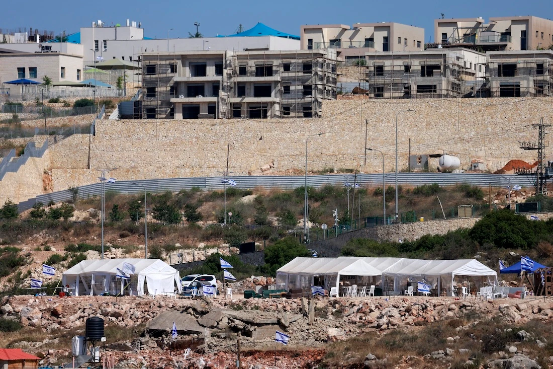 Tents are set up by Israeli settlers in the Palestinian village of Bruqin, outside the walls of an illegal settlement of the same name. (File/AFP)