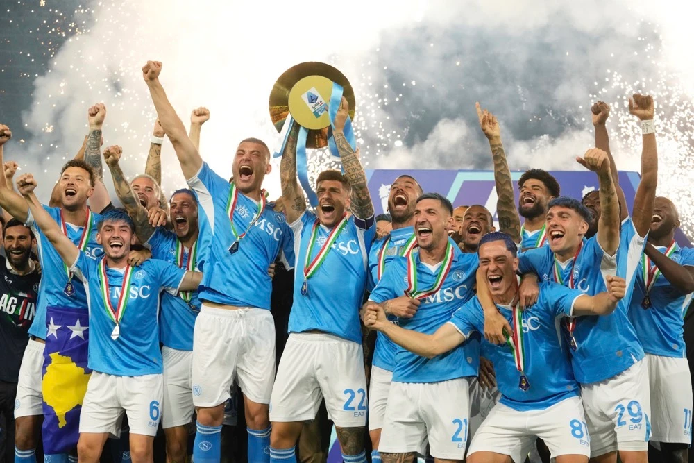 Napoli's players hold the trophy after winning the Italian league soccer title at the end of the Serie A soccer match between Napoli and Cagliari at the Diego Maradona stadium in Naples, Italy. (AP)