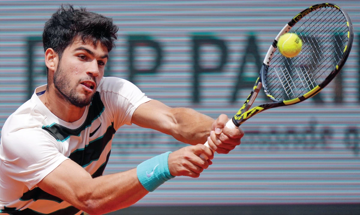 Spain’s Carlos Alcaraz returns the ball to Italy’s Giulio Zeppieri during their first round match of the French Open, at the Roland-Garros. (AP)