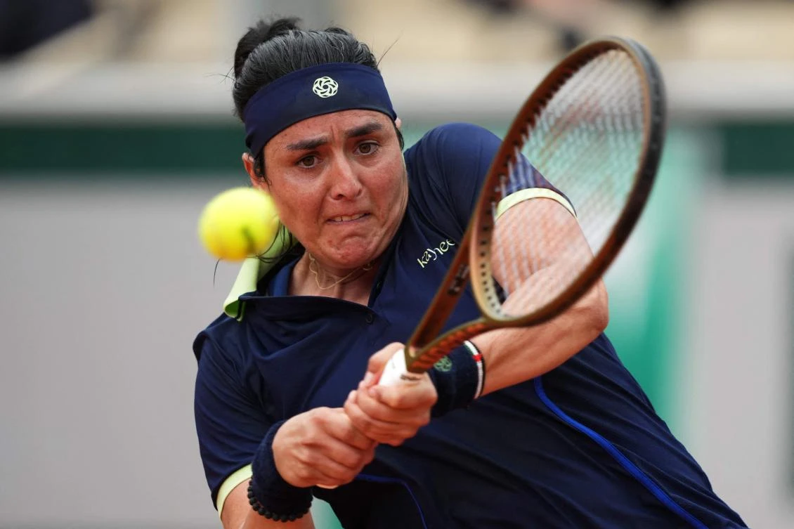 Tunisia’s Ons Jabeur plays a backhand return to Poland’s Magdalena Frech during their women’s singles match on day 3 of the French Open tennis tournament on Court Simonne-Mathieu at the Roland-Garros Complex in Paris on May 27, 2025. (AFP)