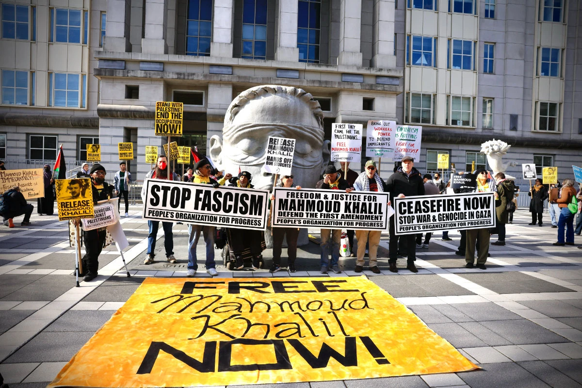 People hold signs as they attend a protest in support of Columbia University student activist Mahmoud Khalil while a hearing takes place outside the court in Newark, New Jersey on March 28, 2025. (AFP)