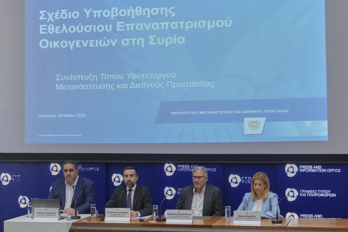 Cyprus’ deputy minister for migration Nicholas Ioannides, 2nd lt, explains how a new voluntary repatriation program for Syrian families will work, Nicosia, Cyprus, Thursday, May 29, 2025. (AP Photo)