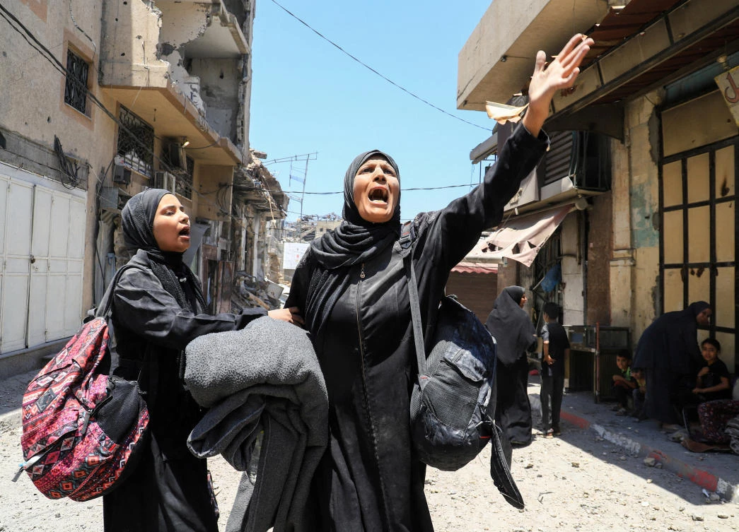 A Palestinian woman reacts in the aftermath of an Israeli strike on a house in Gaza City on May 30, 2025. (Reuters)