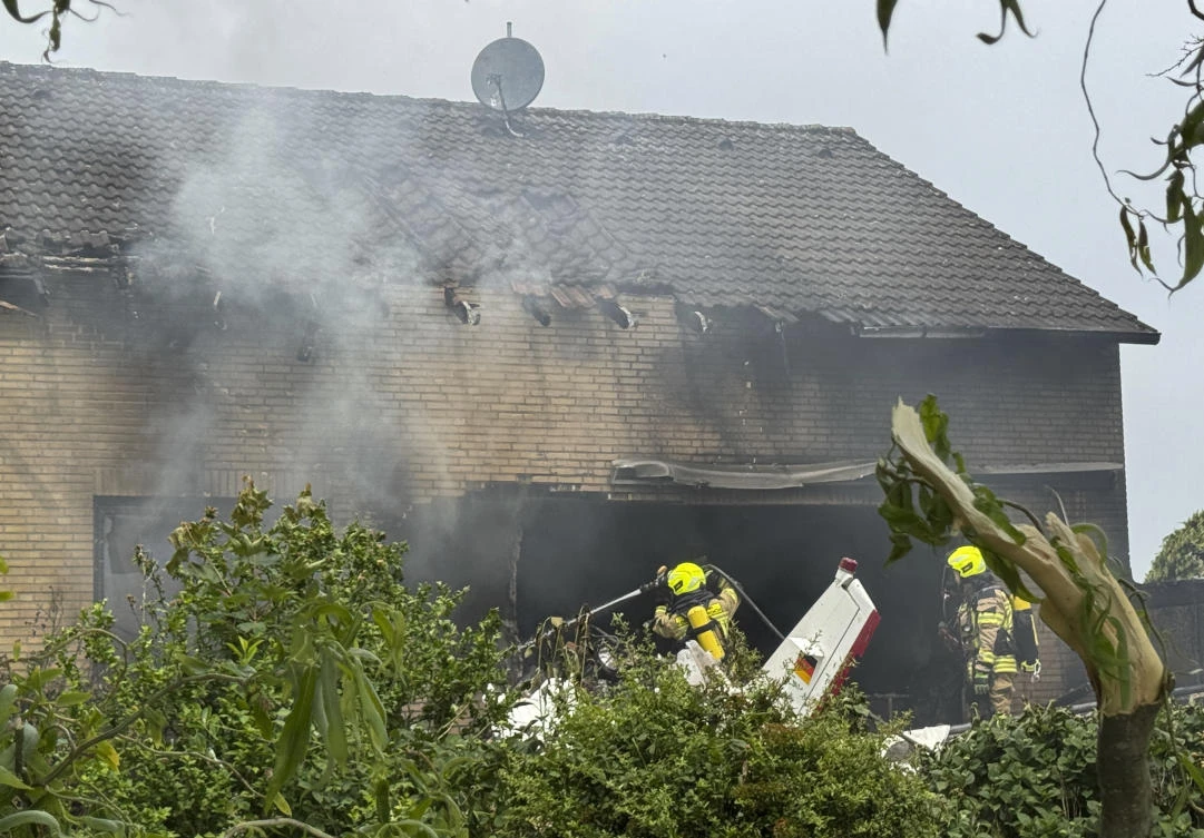 Firefighters work at the crash site after an airplane crashed into a residential building, in Korschenbroich, Germany, May 31, 2025. (AP)