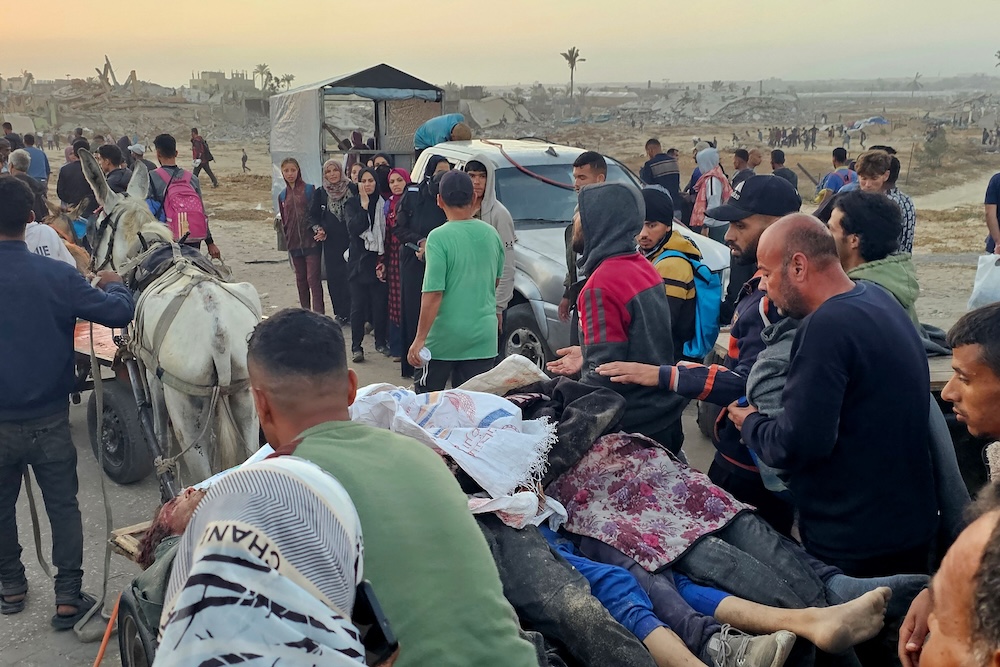 Displaced Palestinians push a cart with bodies after people were reportedly hit by Israeli fire as they headed to a food distribution center in Rafah in the southern Gaza Strip on June 1, 2025. (AFP)