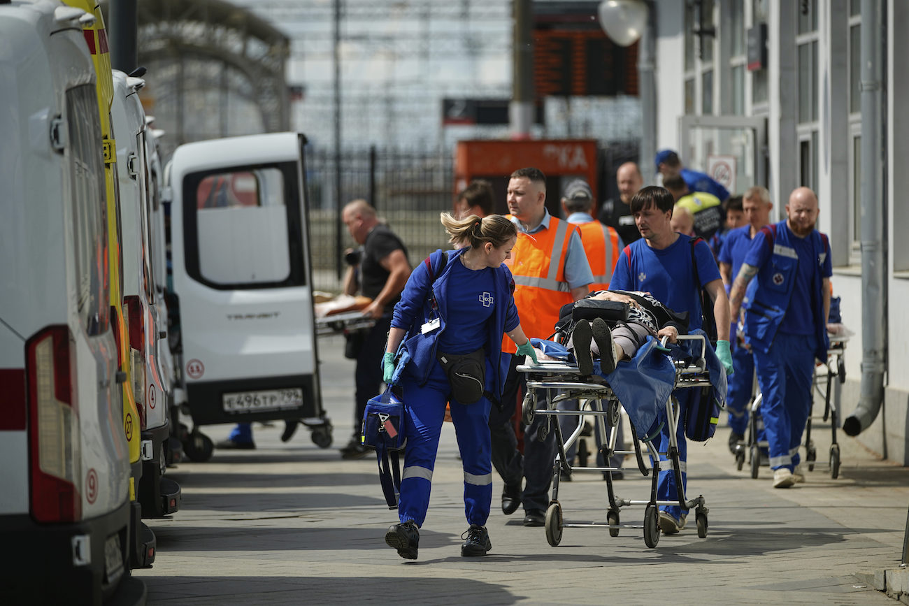 Emergency medics transport a wounded passenger after a road bridge collapsed on top of a passenger train in the Bryansk region, June 1. (AP)